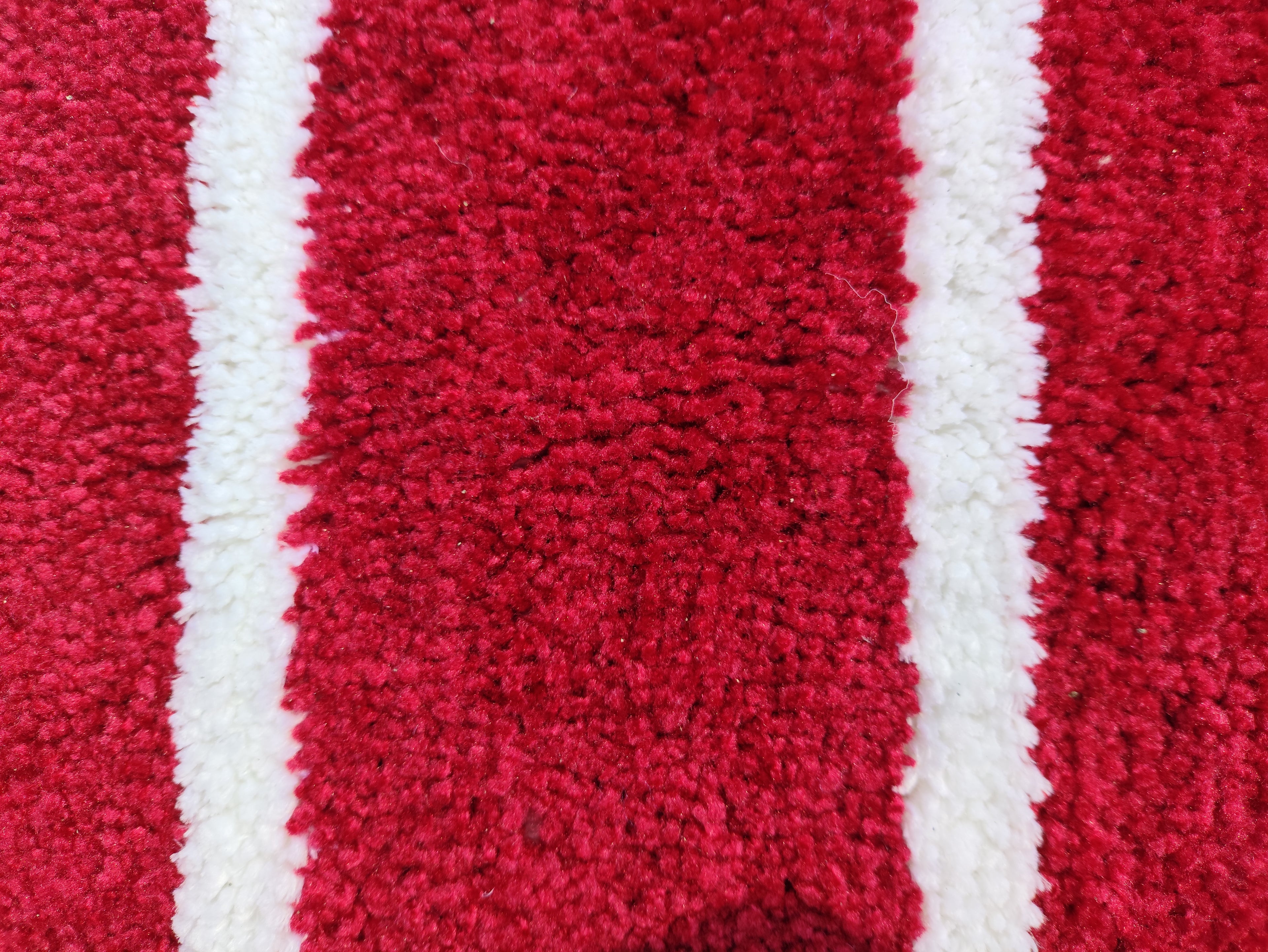 Microfiber stripe bathmat by IR Home Furnishing featuring modern design and soft, absorbent material for bathroom use.
